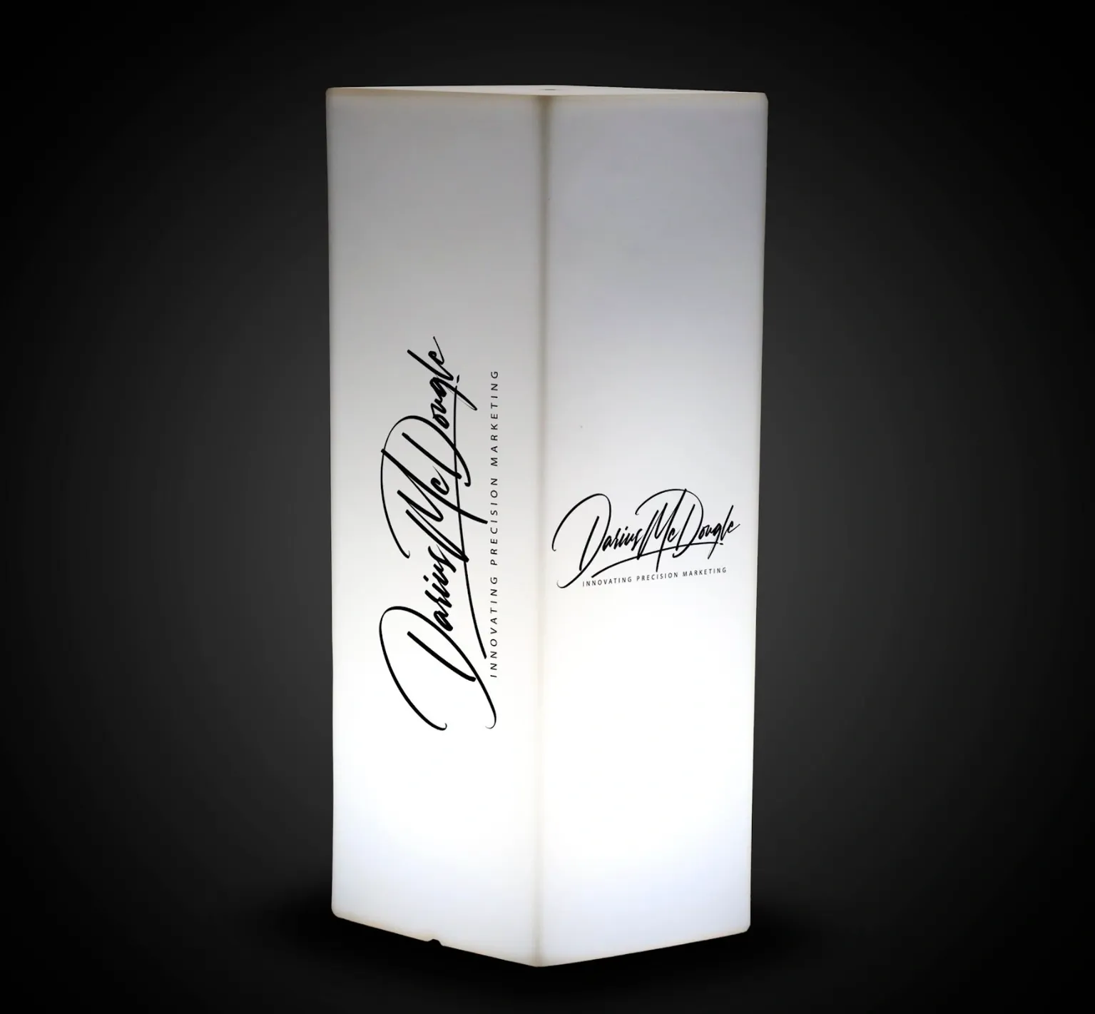 Illuminated display bearing Darius McDougle's signature and Innovative Precision Marketing wordmark